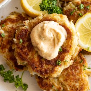 Crab cake with a dollop of sauce on top.