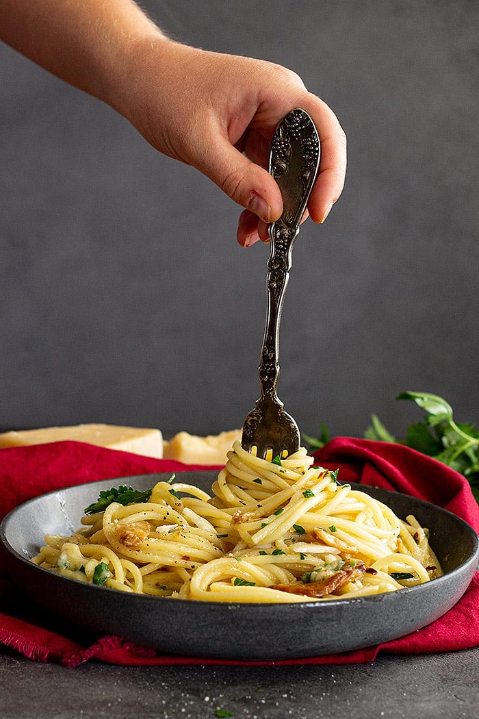 Twirling pasta onto a fork.