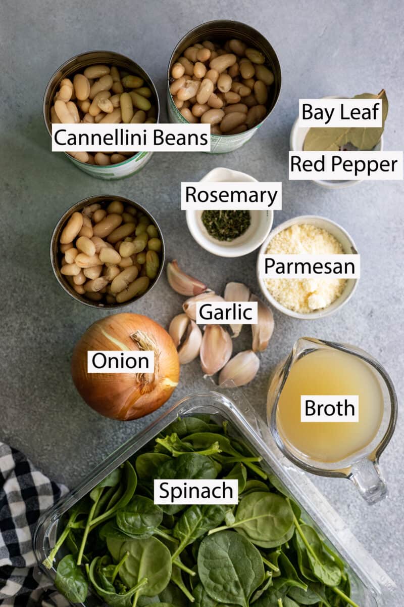 Ingredients: cannellini beans, rosemary, bay leaf, red pepper flakes, onion, garlic, broth, spinach, and Parmesan.