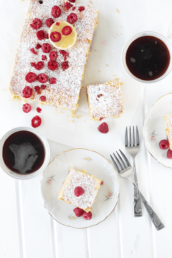 An overhead shot of the lemon raspberry coffee cake beside a cup of coffee