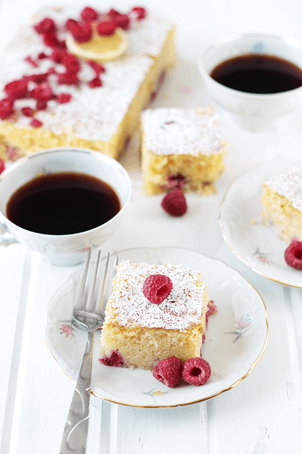 mugs of coffee served with slices of lemon raspberry coffee cake